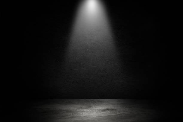 istock Studio dark room black concrete wall and spotlight with concrete floor. 1209442451