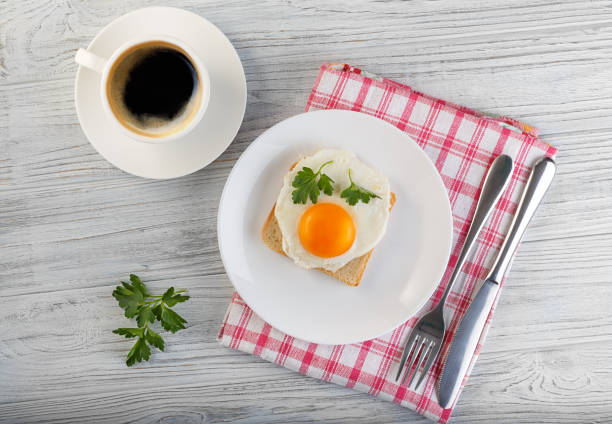 istock coffee fried egg bread parsley sandwich wooden white 1209444761