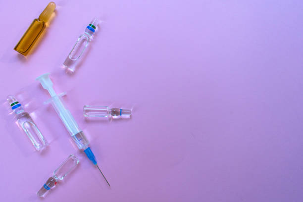 istock Tablets, ampoules and capsules. Medical preparations on a purple background. 1209444901