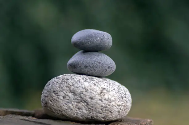 Photo of Harmony and balance, cairns, simple poise stones on white background, rock zen sculpture, white pebbles, single tower, simplicit