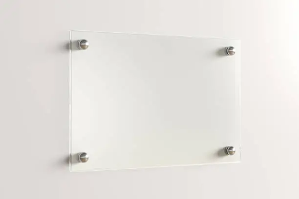 Photo of Blank transparent glass sign plate on the wall.