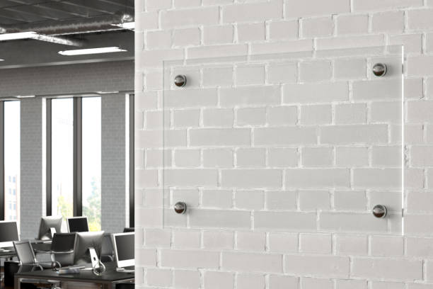 istock Blank transparent glass sign plate on the wall. 1209446162