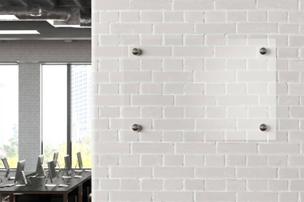 istock Blank transparent glass sign plate on the wall. 1209446709