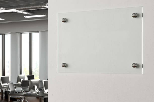 istock Blank transparent glass sign plate on the wall. 1209446747