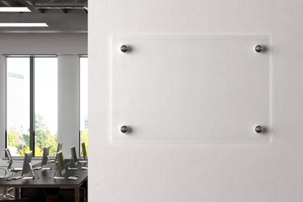 istock Blank transparent glass sign plate on the wall. 1209446785