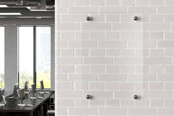 istock Blank transparent glass sign plate on the wall. 1209446830
