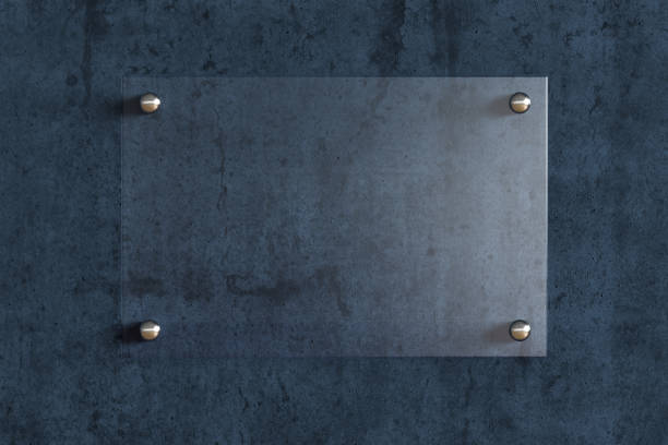 istock Blank transparent glass sign plate on the wall. 1209446853