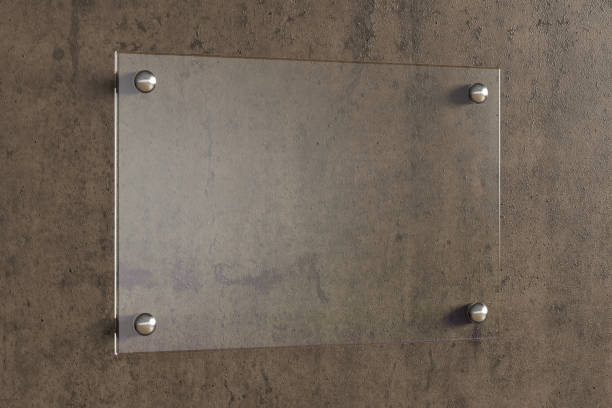 istock Blank transparent glass sign plate on the wall. 1209446865