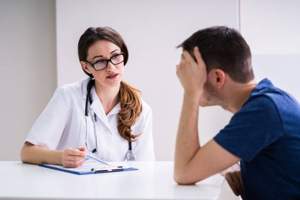 istock Doctor Comforting Patient At Table 1209448764