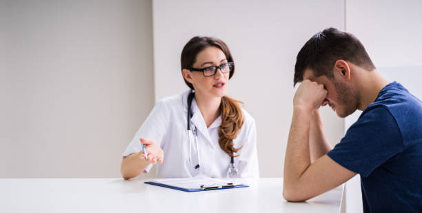 istock Doctor Comforting Patient At Table 1209449274