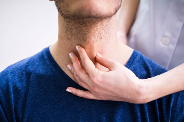 istock Doctor Checking Thyroid Of A Young Man 1209449982
