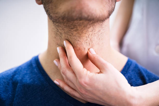istock Doctor Checking Thyroid Of A Young Man 1209449984