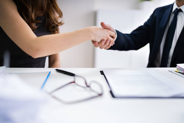 Business Partners Shaking Hands Business Partners Shaking Hands Over Contract Form mediation photos stock pictures, royalty-free photos & images