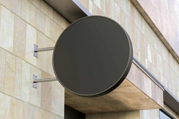 istock Round signboard or signage on the marble wall with blank black sign mock up. Bottom view. 1209450314