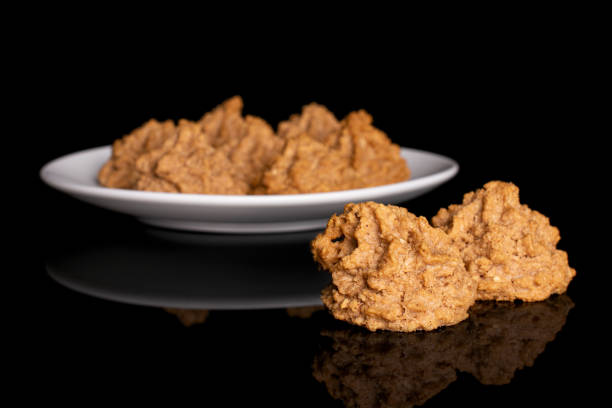 istock Coconut chocolate biscuit isolated on black glass 1209450873