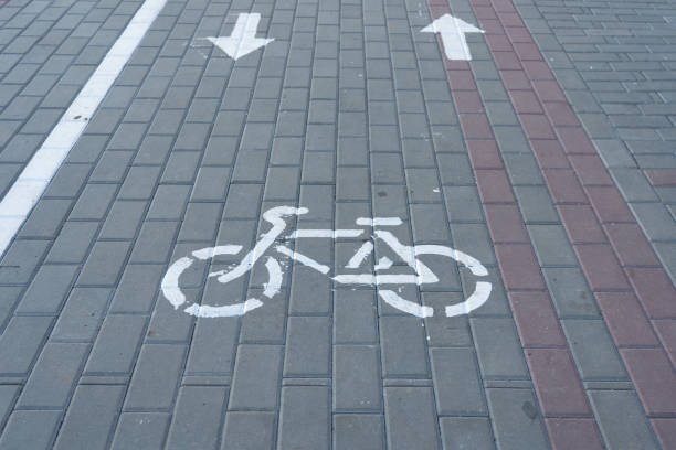 istock white bike road sign painted on asphalt 1209456165
