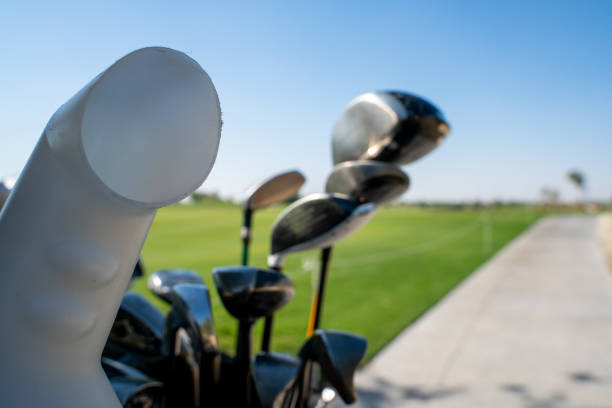 istock Background image of multiple golf sticks on the behind of a golf cart. 1209456372