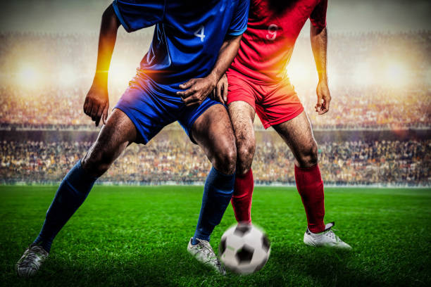 istock Soccer players performs an action play in stadium. 1209456943