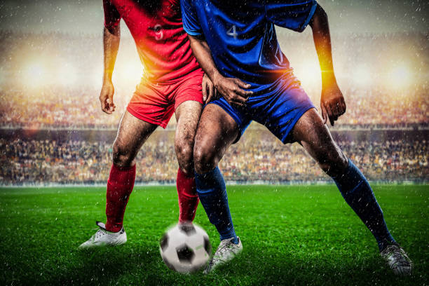 istock Soccer players performs an action play in stadium. 1209457083