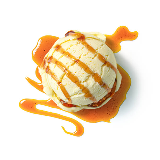 istock Vanilla ice cream ball with caramel syrup isolated on white background 1209457300