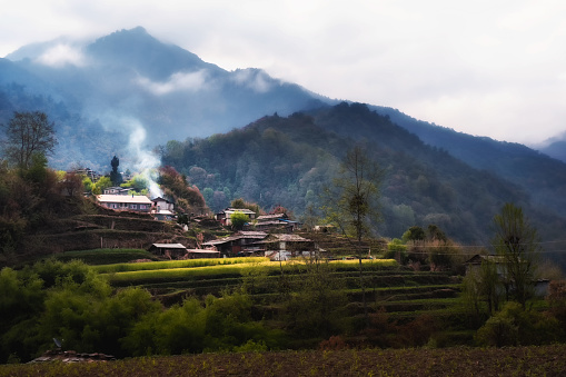 A Himalayan village in dramatic light with blurred background