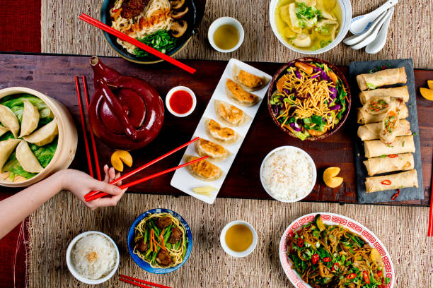 istock Chinese restaurant Chinese New Years celebration dinner meal with multiple courses and dishes served at the table. Lo Mein. Noodles. Beef Dish. Rice. Classic family style meal. 1209458656