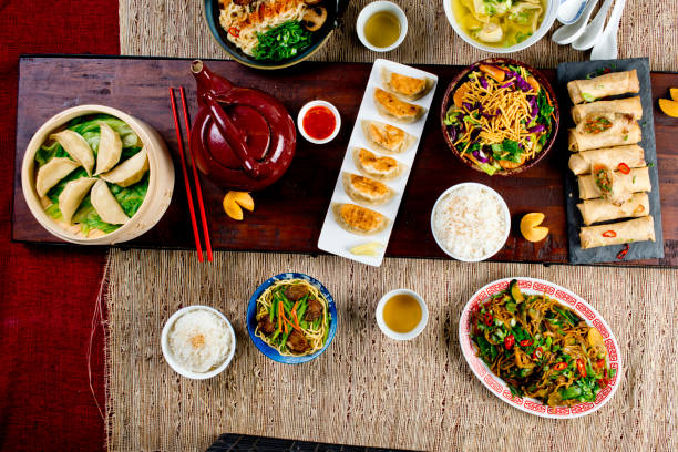 istock Chinese restaurant Chinese New Years celebration dinner meal with multiple courses and dishes served at the table. Lo Mein. Noodles. Beef Dish. Rice. Classic family style meal. 1209458694
