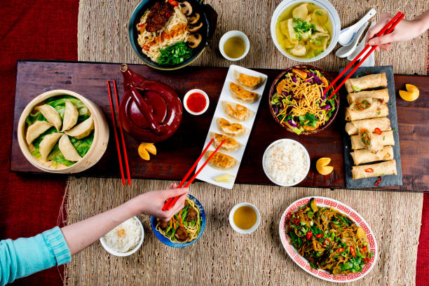 istock Chinese restaurant Chinese New Years celebration dinner meal with multiple courses and dishes served at the table. Lo Mein. Noodles. Beef Dish. Rice. Classic family style meal. 1209458843