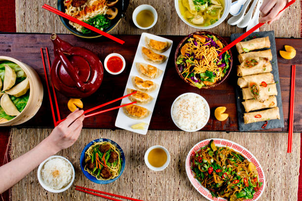 istock Chinese restaurant Chinese New Years celebration dinner meal with multiple courses and dishes served at the table. Lo Mein. Noodles. Beef Dish. Rice. Classic family style meal. 1209458878