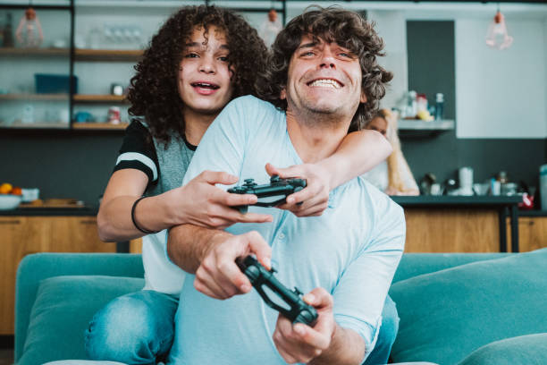istock Father and son playing digital games at home 1209459622