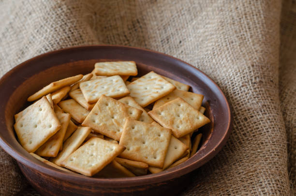 istock Salty Crackers in a clay bowl on burlap. 1209459927