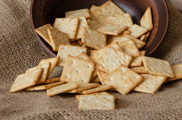 istock Pile of salted crackers on burlap. 1209460063