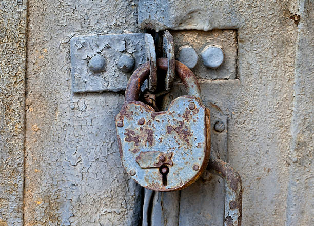 istock Rusty padlock on an old metal door 120946243