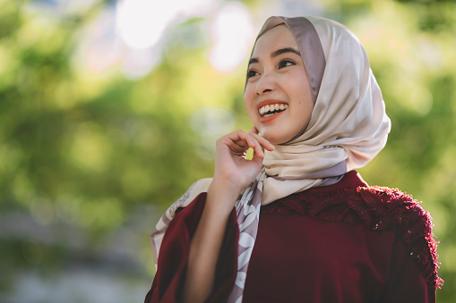 a modern muslim women portrait outdoor during day time in capital city of kuala lumpur with hijab and traditional clothing
