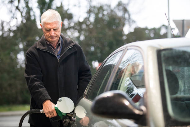 Senior Man Refueling Car Gas Tank stock photo