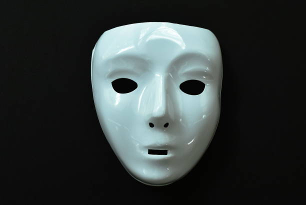 istock white plastic human face mask on black background 1209468309