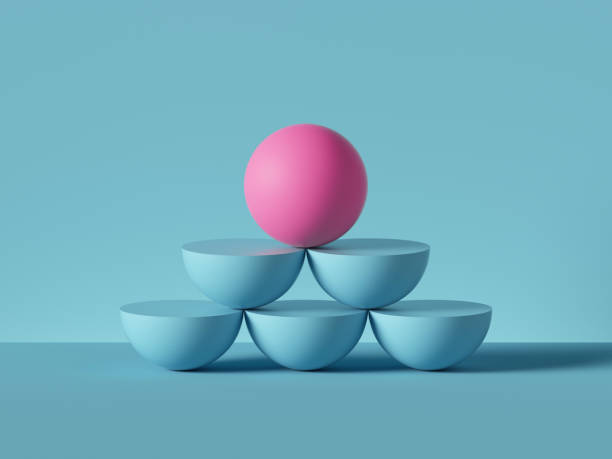 istock 3d render, abstract primitive geometric shapes isolated on blue background. Pink ball placed on top of pyramid, rows of blue hemispheres. Balance concept. Success metaphor. Modern minimal design 1209468700