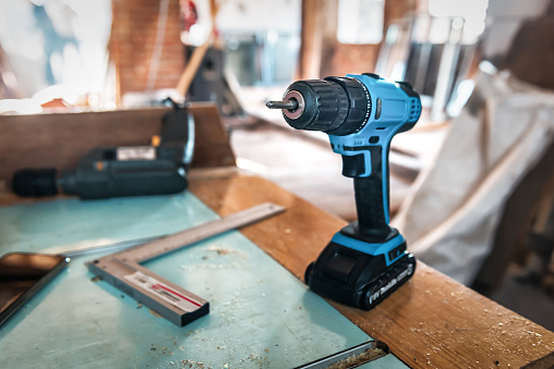 Blue used electric screw driver. Professional electric drill, cordless screwdriver