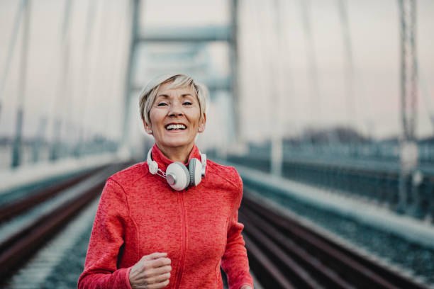 istock Seniors woman jogging 1209468952