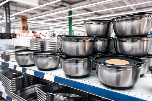 various metal utensils on the shelves in the supermarket