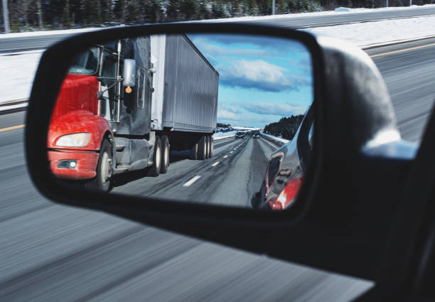 istock Semi Truck in Side Mirror 1209472849