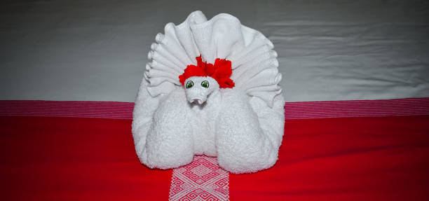 Spa massage setting with thai massage chairs and towel in swan form