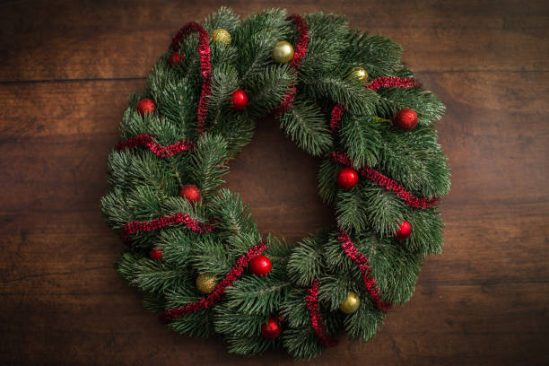 istock Christmas wreath decoration on wooden table 1209474418