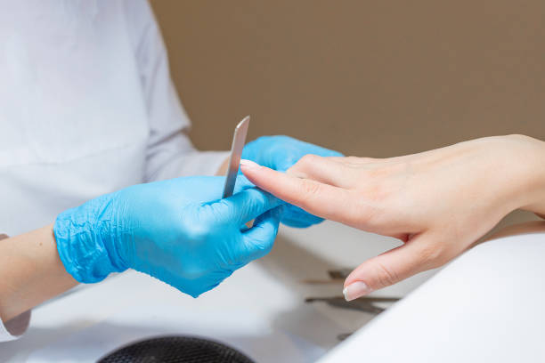 istock Manicure procedure with a file for nails in beauty salon. 1209477958