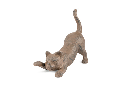 bronze figurine of a lying playful cat with a raised paw and tail isolated on white background