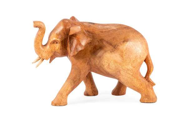istock wooden elephant figurine on white 1209482992