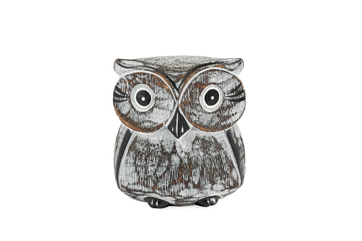 old wooden figurine of an owl with big eyes isolated on white background