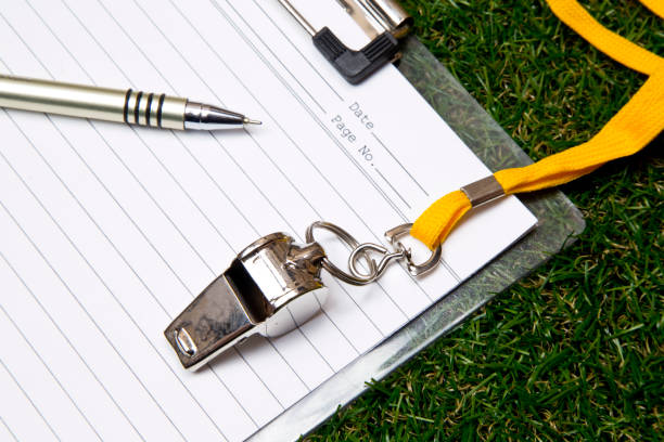 istock Sport whistle with pen and clipboard on grass 1209484165