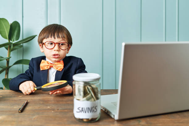 2-3 years old child wearing a suit like a businessman and he work in his office table. - 2 3 years fotos imagens e fotografias de stock