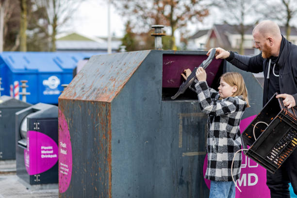 istock Father and daughter recycling plastic 1209486864